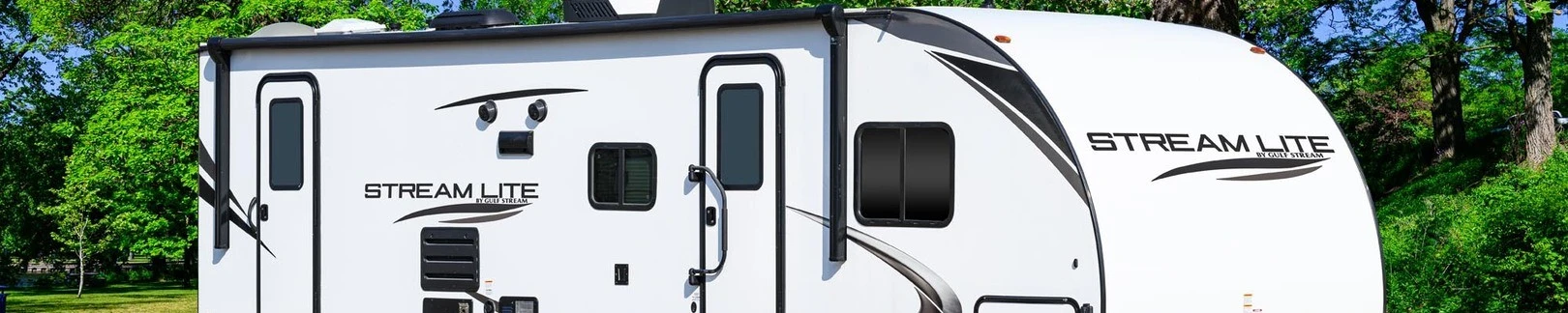 A Gulf Stream Stream Lite RV with a white exterior and sleek black accents